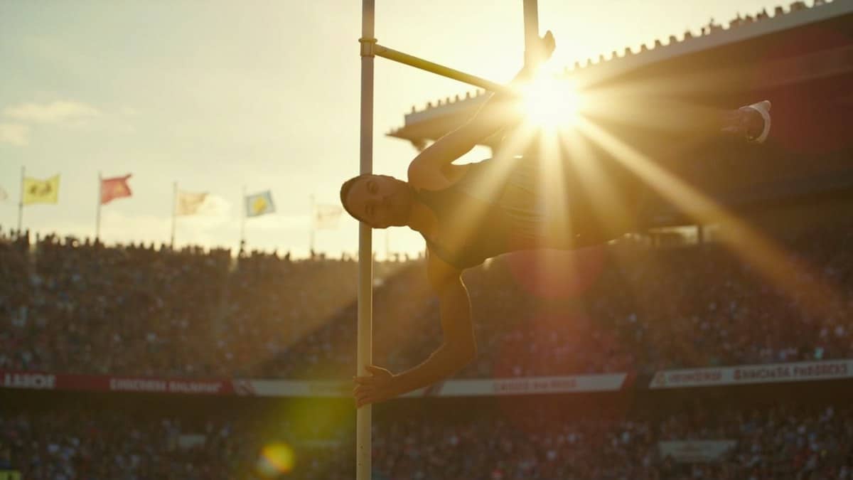 olympic athletes 2026 - pole vaulter clearing the bar in packed stadium