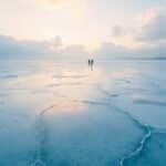 unexplained mysteries 2026 - a frozen-over lake in Kazakhstan with refrozen glass-like plates across the surface at dawn